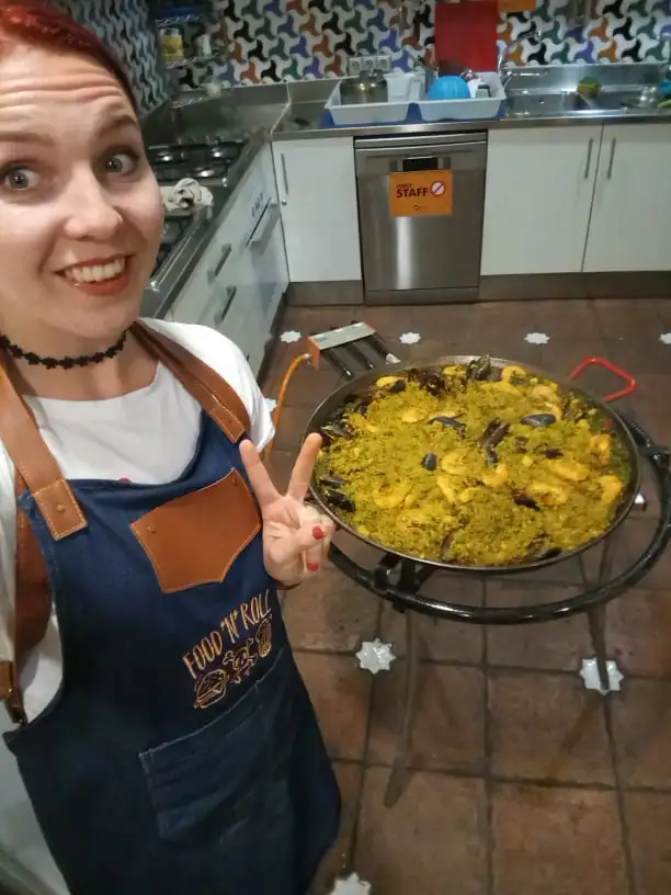 Elina prend un selfie devant un pot de paella