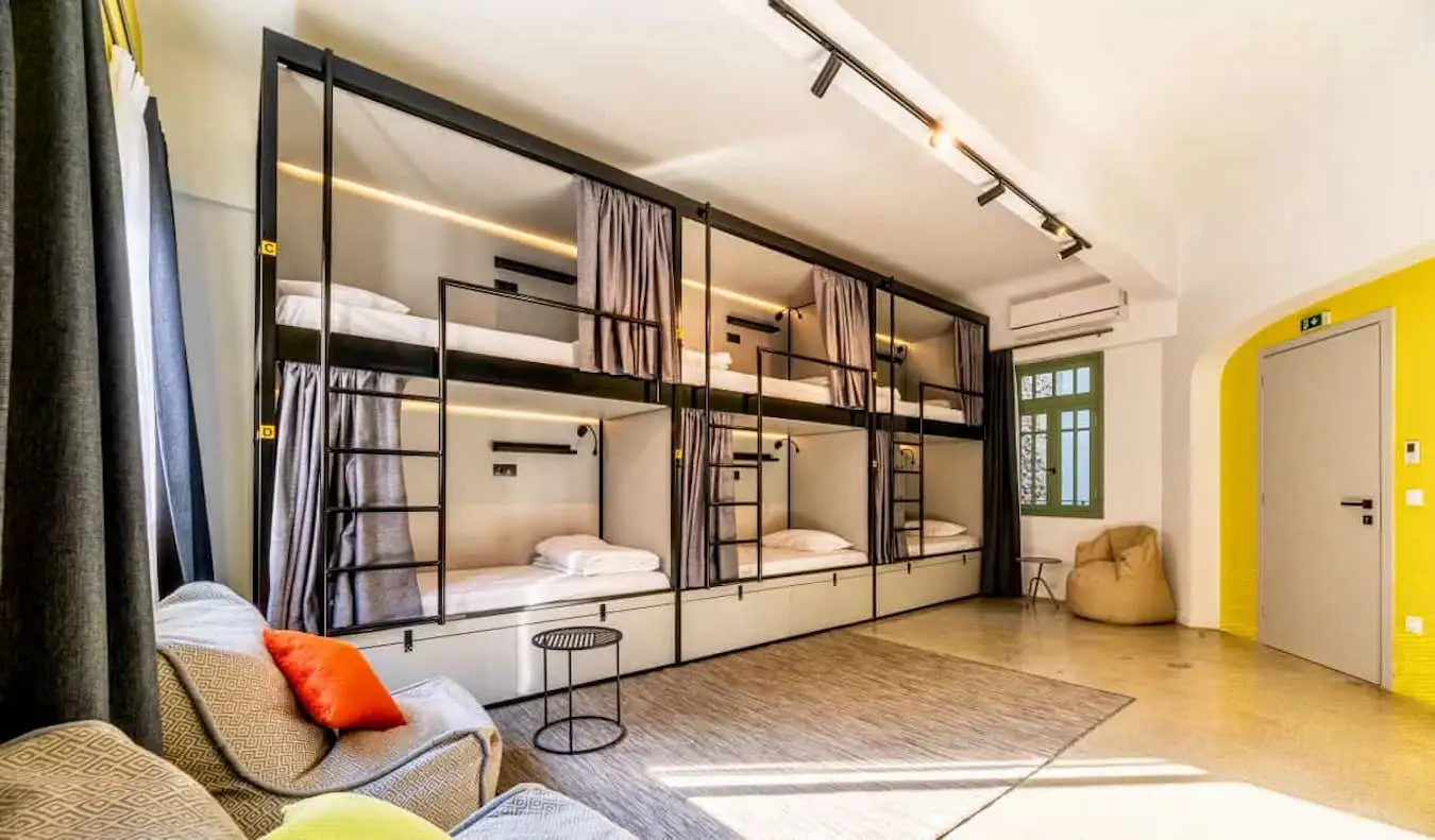Um dormitório enorme com beliches grandes no albergue Athens Hub em Atenas, Grécia