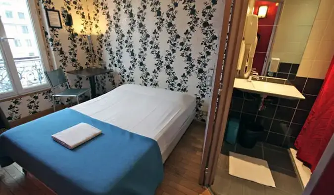 quarto com cama de casal e banheiro privativo no Oops Hostel