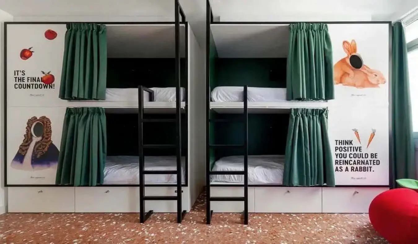 Deux lits superposés de style capsule avec des citations et des images d'Isaac Newton et des lapins au 2060 The Newton Hostel à Madrid, en Espagne.