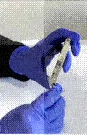 Locate the opening at the top of the canister and use the tool in a counterclockwise motion to open the top of the canister - Illustration