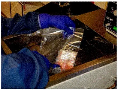 Carefully place the unit inside a sterile sealable zip-lock bag and submerge in the 37°C water bath keeping port(s) dry and above water - Illustration